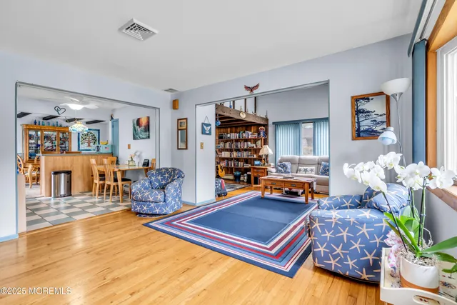 a living room filled with furniture and a potted plant