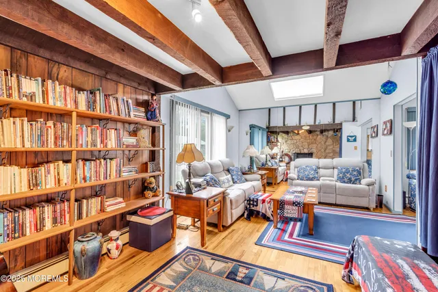a living room with lots of furniture and a book shelf