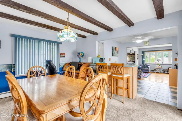 a dining hall with furniture a chandelier and window