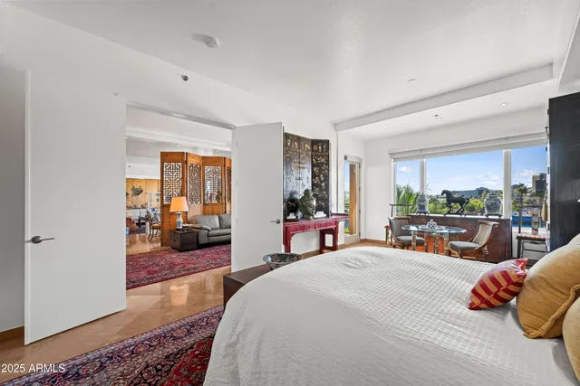 a dining room with furniture a chandelier and wooden floor