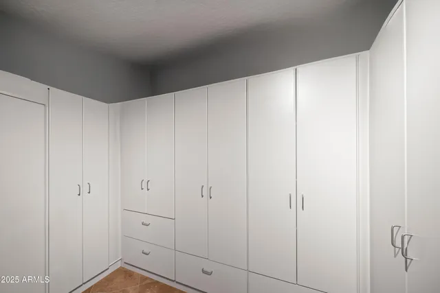 a view of a balcony with two chairs and a potted plant