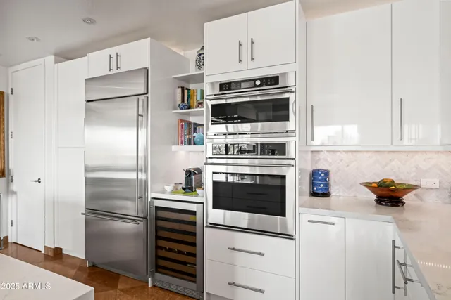 a living room with fireplace furniture and a large window
