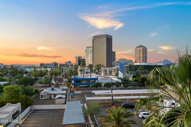 a view of a swimming pool with a lounge chair and back yard of the house
