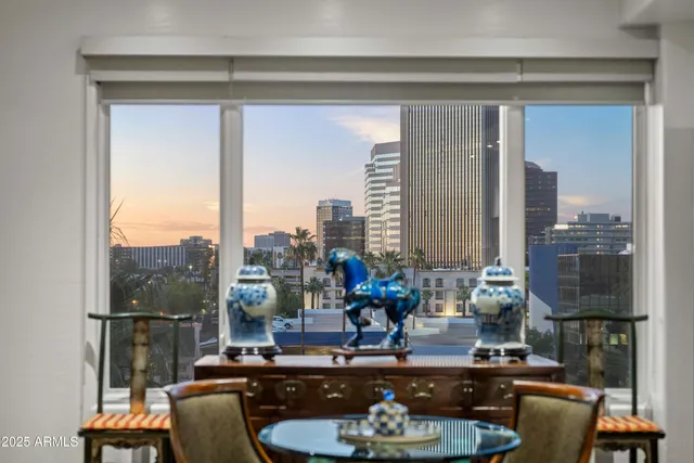 a view of a patio with a table chairs and a swimming pool