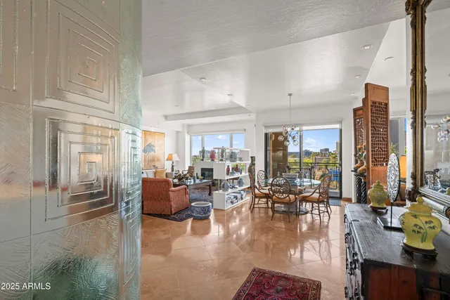 a dining room with furniture a chandelier and window