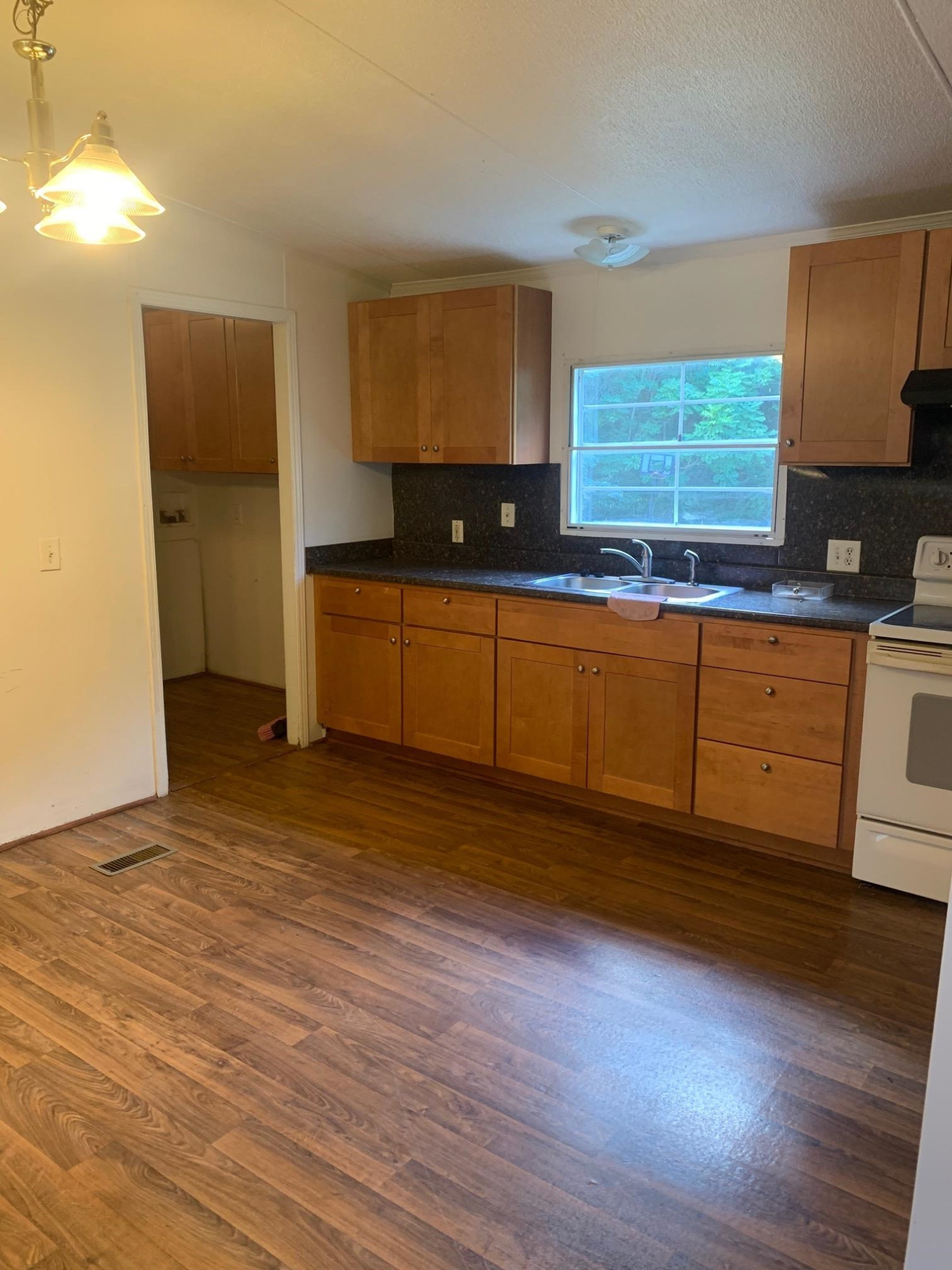 326 Everett Avenue Roxboro, NC 27574 - Photo 3 of 10 a kitchen with granite countertop wooden floors and granite counter tops