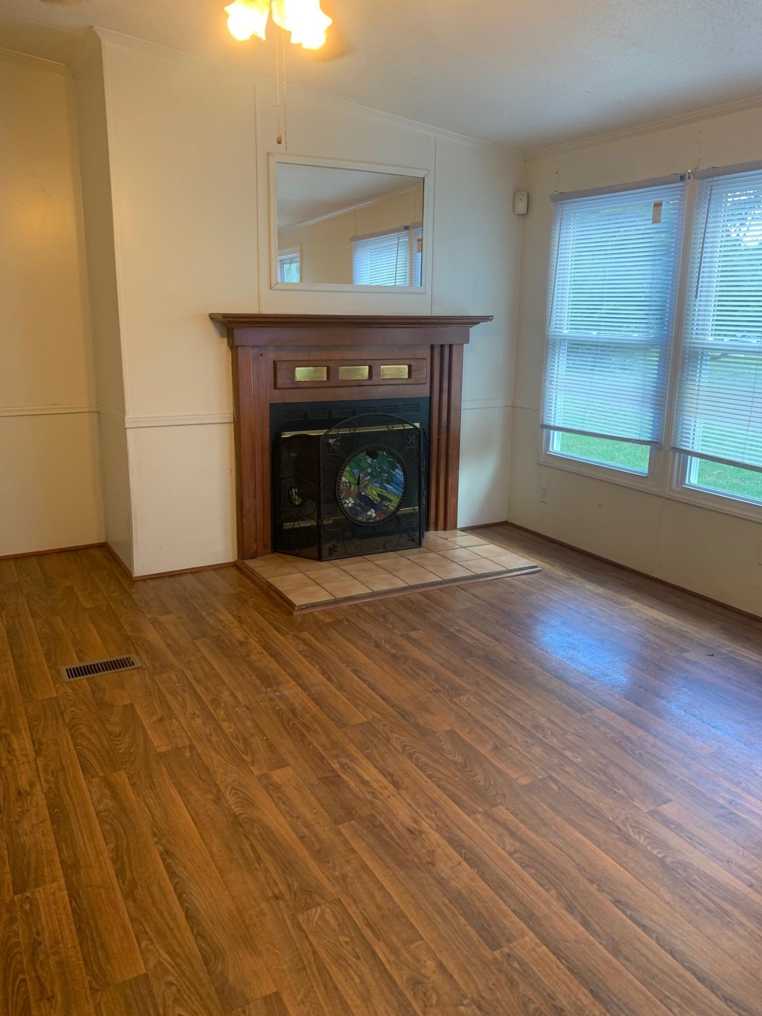 326 Everett Avenue Roxboro, NC 27574 - Photo 6 of 10 a view of an empty room with window and fire place