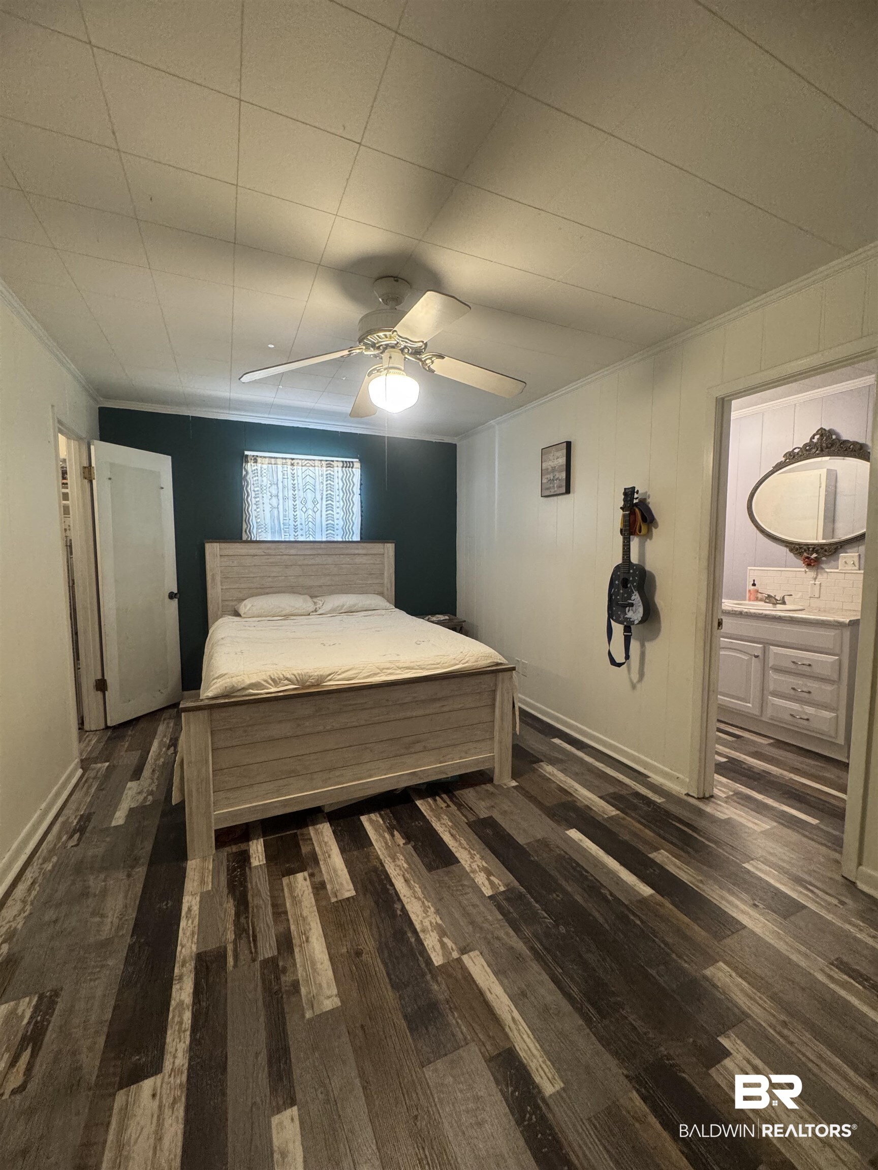 3097 Old Castleberry Road Brewton, AL 36426 - Photo 12 of 49 Bedroom #3 with ornamental molding, ensuite bathroom, dark wood-type flooring, and ceiling fan