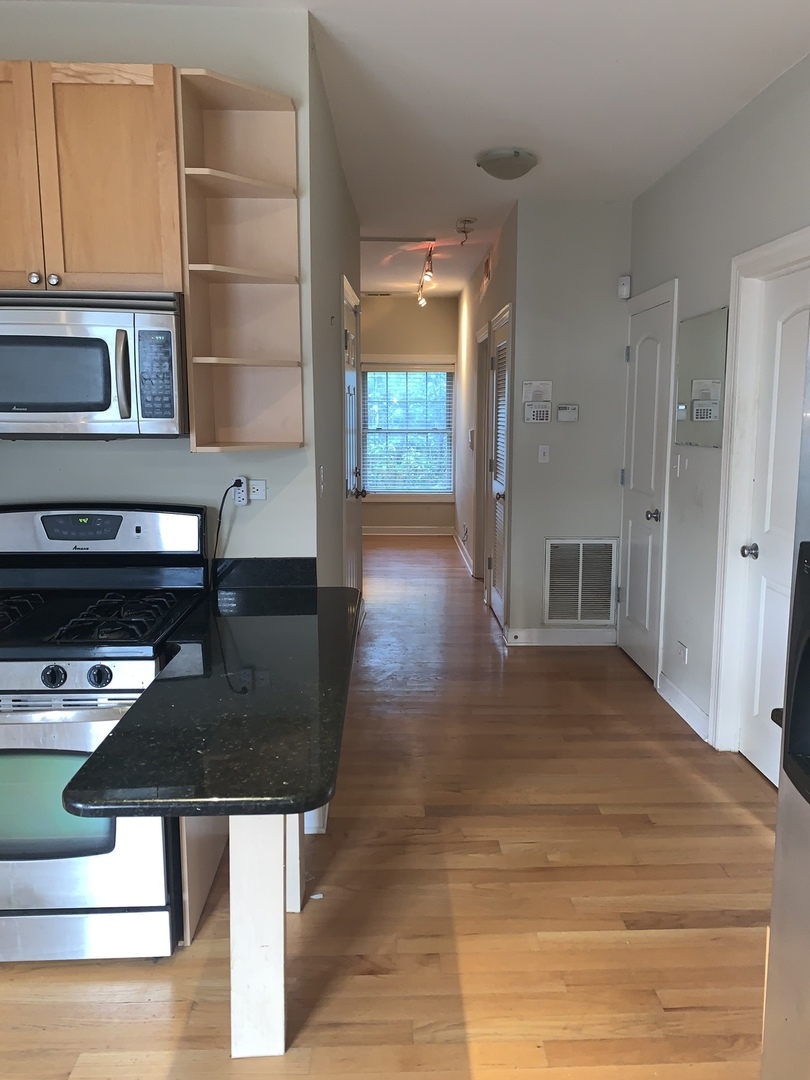 839 East 52nd Street, Unit 3 Chicago, IL 60615 - Photo 4 of 18 a kitchen view with a stove a faucet and a refrigerator