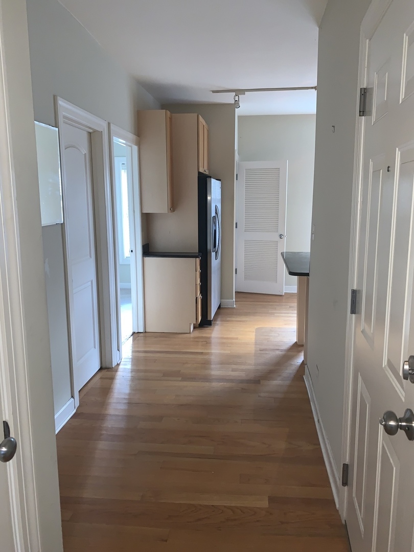 839 East 52nd Street, Unit 3 Chicago, IL 60615 - Photo 6 of 18 a view of a hallway with wooden floor and a cabinet