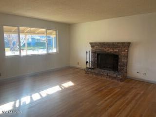 an empty room with windows and fireplace