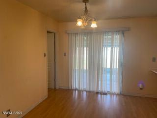 908 Wagner Drive Carson City, NV 89703 - Photo 4 of 8 a view of an empty room with wooden floor and a window