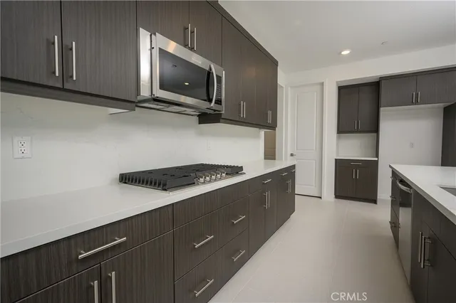 a kitchen with a refrigerator stove and microwave