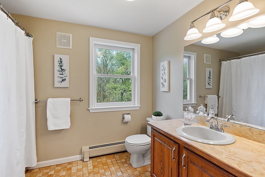 7 Cameron Road Harvard, MA 01451 - Photo 25 of 42 a bathroom with a granite countertop sink toilet and a mirror