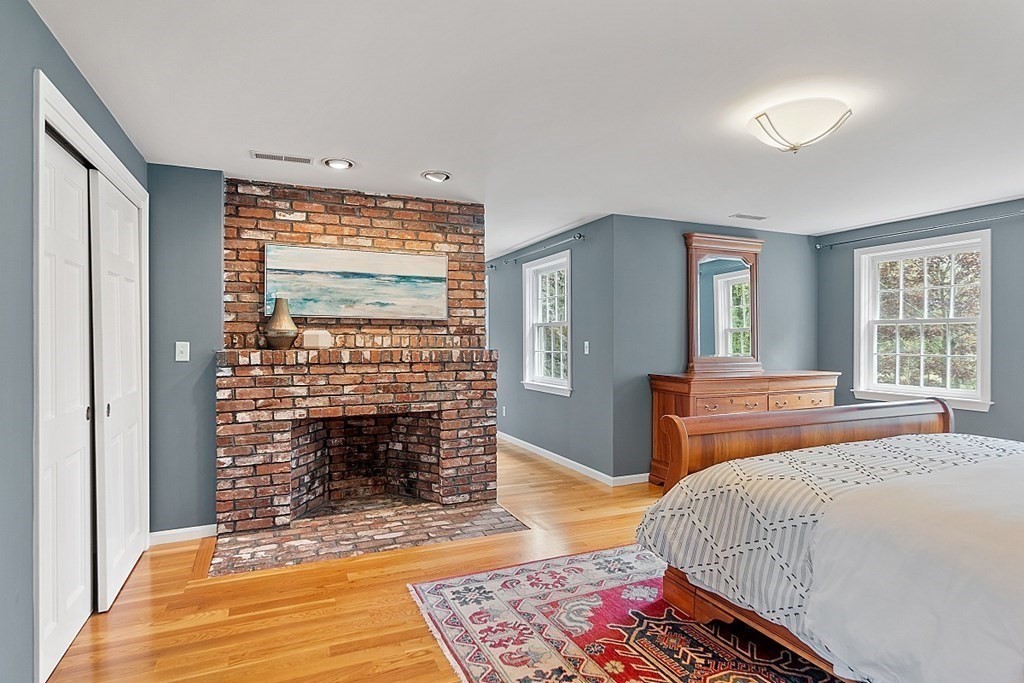 7 Cameron Road Harvard, MA 01451 - Photo 26 of 42 a bedroom with a bed a fireplace and next to a window