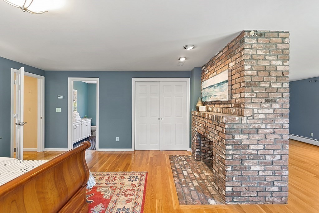 7 Cameron Road Harvard, MA 01451 - Photo 29 of 42 a bedroom with a bed and a lamp next to a window