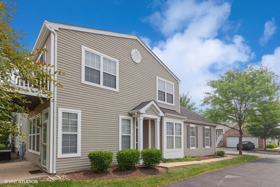 5111 Freeport Court Plainfield, IL 60586 - Photo 1 of 24 a front view of a house with garden