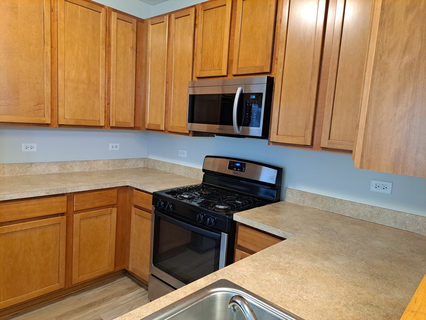 5111 Freeport Court Plainfield, IL 60586 - Photo 11 of 24 a kitchen with stainless steel appliances wooden cabinets and a stove top oven