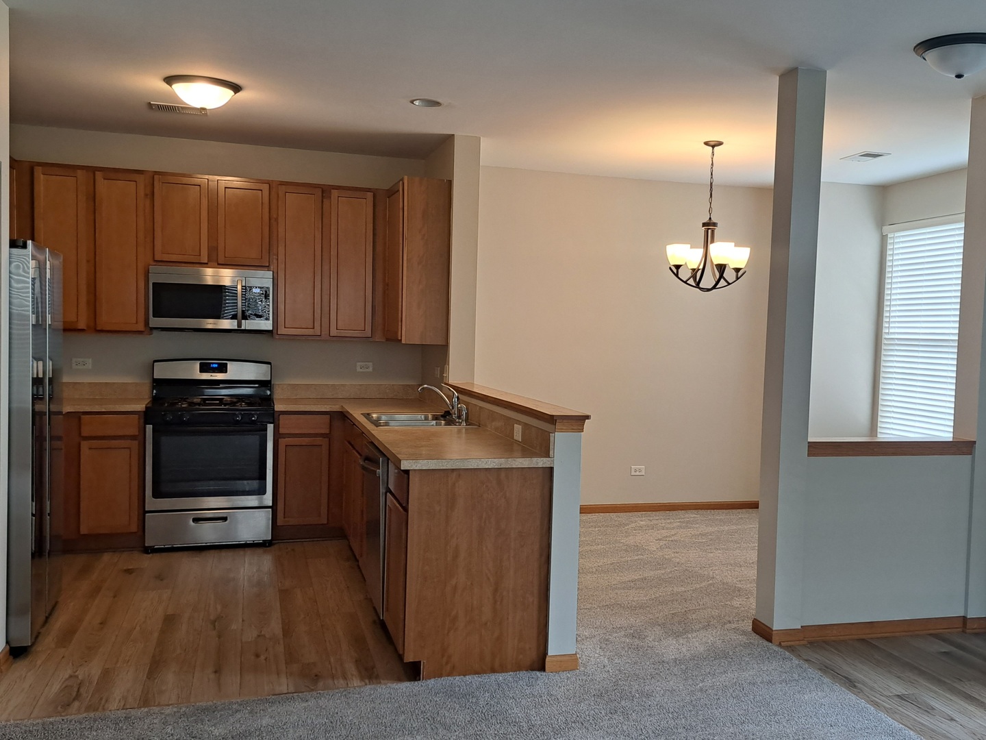 5111 Freeport Court Plainfield, IL 60586 - Photo 13 of 24 a kitchen with stainless steel appliances a stove and a refrigerator