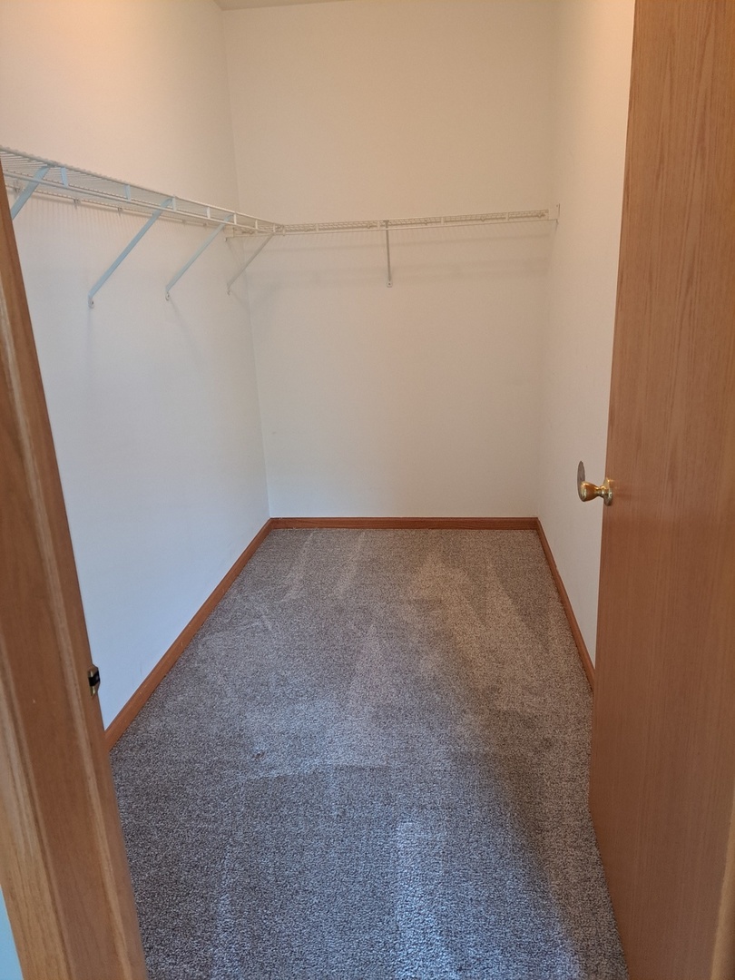 5111 Freeport Court Plainfield, IL 60586 - Photo 18 of 24 a view of a room with racks on the wall