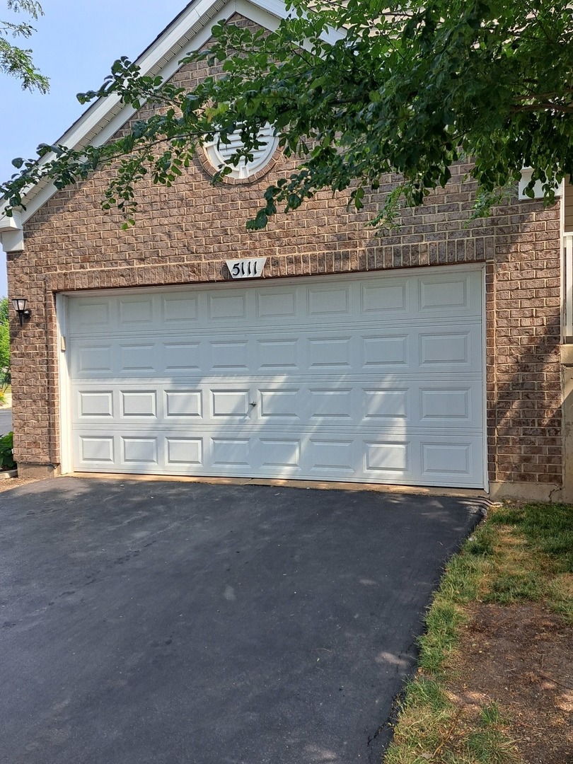5111 Freeport Court Plainfield, IL 60586 - Photo 4 of 24 a view of a house with a yard and a large tree