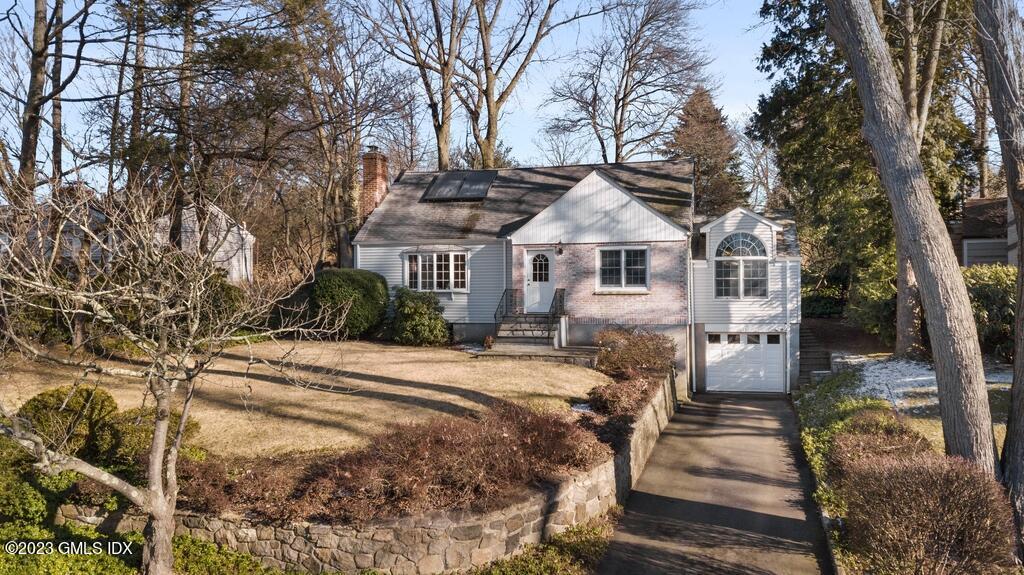 11 Somerset Lane Riverside, CT 06878 - Photo 1 of 2 a front view of a house with a yard