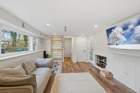 a living room with furniture and a book shelf