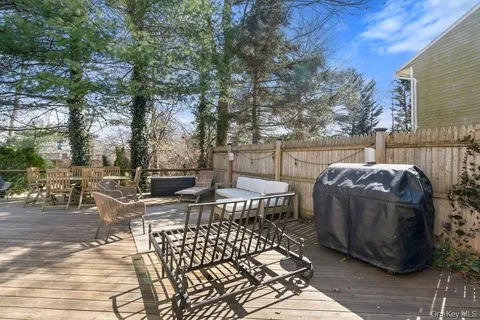 a view of a patio with table and chairs and floor to ceiling window