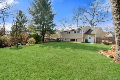 a house view with a sitting space and garden