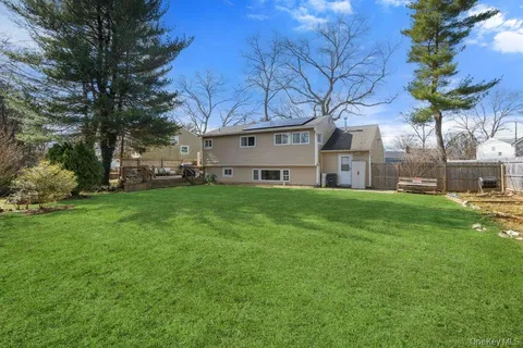 a view of a house with a yard and garage