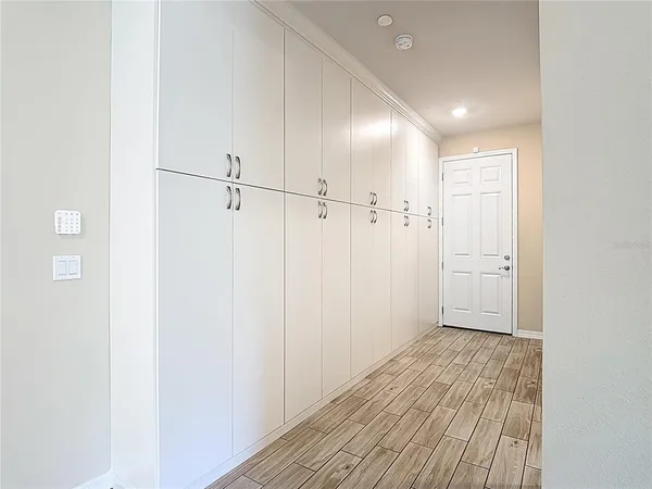 a view of hallway with wooden floor
