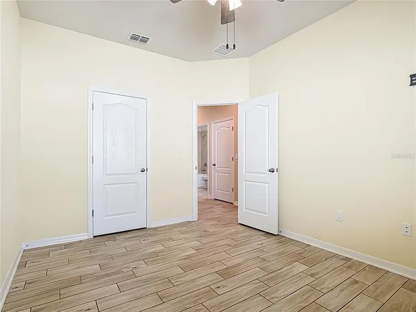 a view of an empty room with wooden floor
