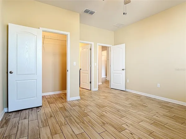 a view of a room with wooden floor and white doors