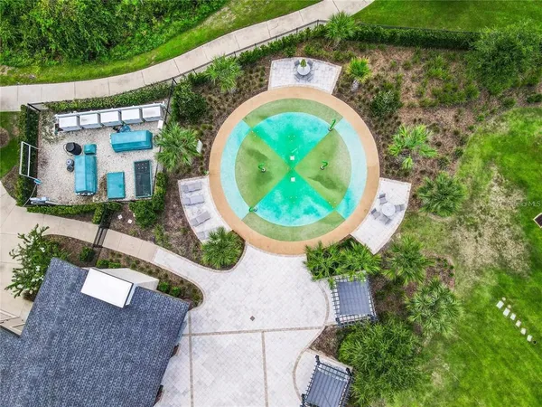 an aerial view of a house with garden space and swimming pool