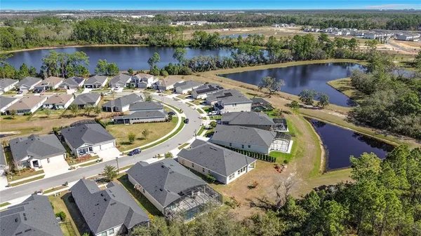 an aerial view of a house with a lake view