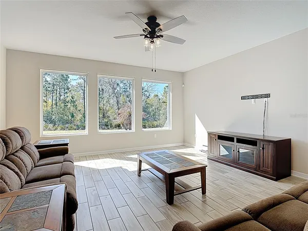 a living room with furniture a window and a chandelier