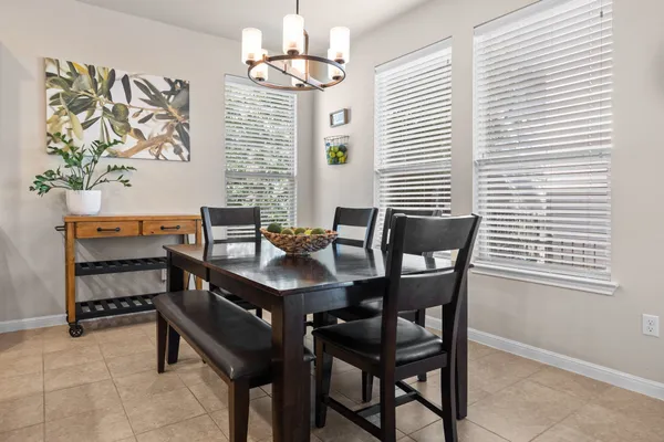 a view of a dining room with furniture and chandelier