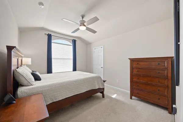 a bedroom with a bed and a dresser