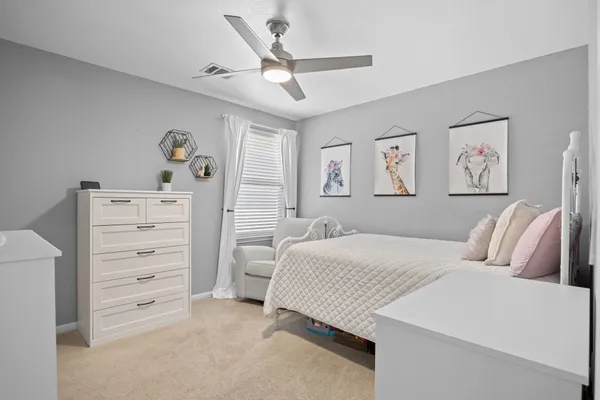 a spacious bedroom with a bed and a window