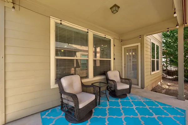a balcony with furniture and a rug