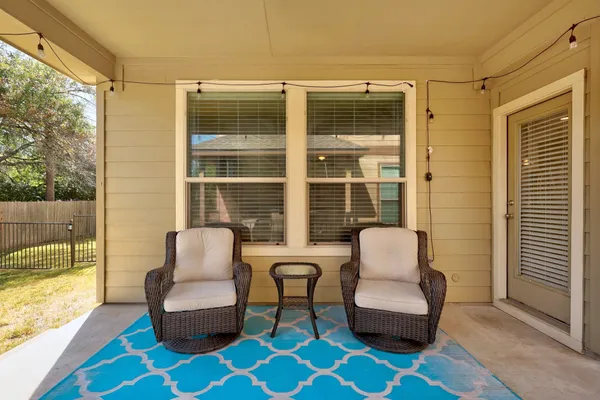 a balcony with furniture and a potted plant