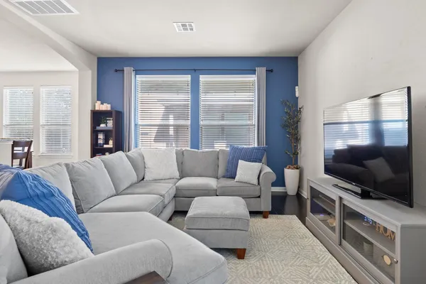 a living room with furniture and a flat screen tv