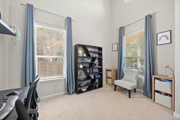 a view of a livingroom with furniture and a window