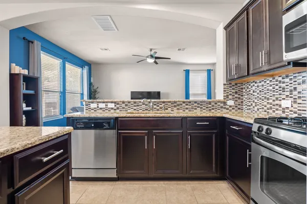 a kitchen with a stove and cabinets