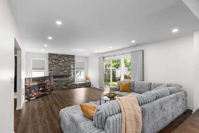 a living room with furniture window and wooden floor