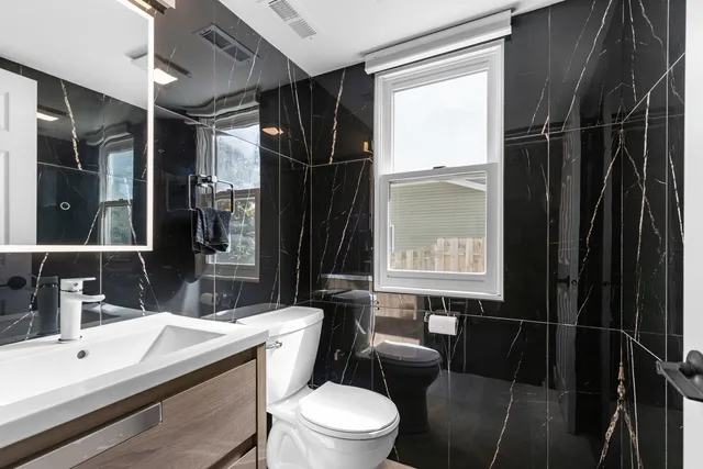 a bathroom with a sink toilet and shower