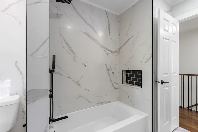 a bathroom with a bathtub and a shower