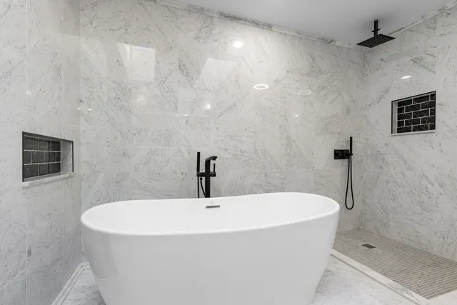 a white bath tub sitting in a bathroom