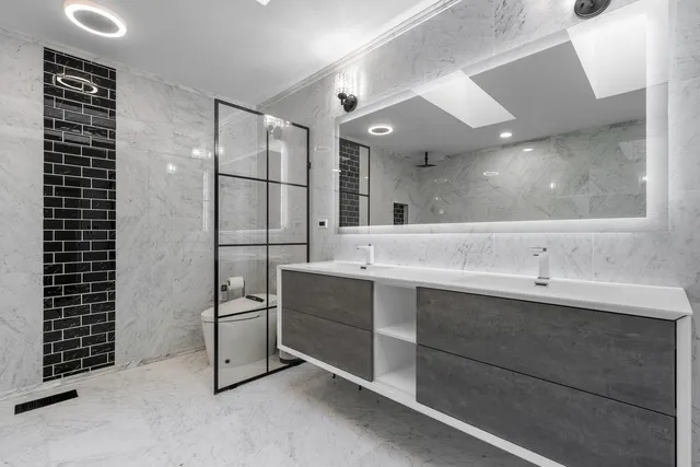 a bathroom with a sink double vanity and a shower