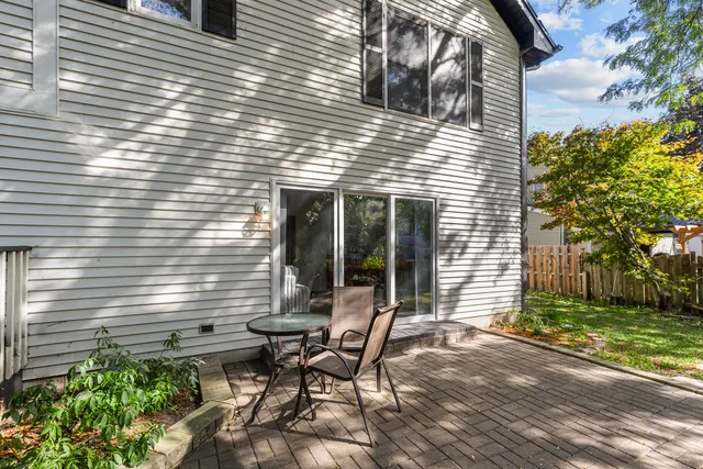 a view of a house with backyard and sitting area